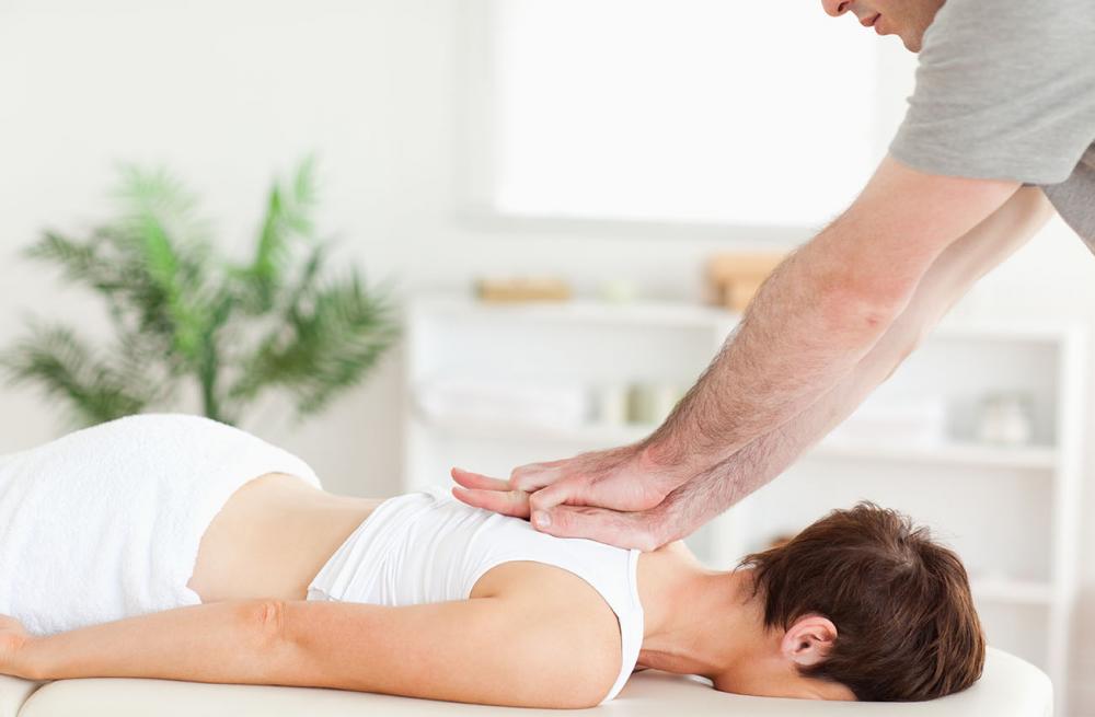 chiropractic adjusting patient with neck and back pain in chesapeake