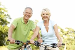 elderly couple happily riding their bike sin Chesapeake, VA
